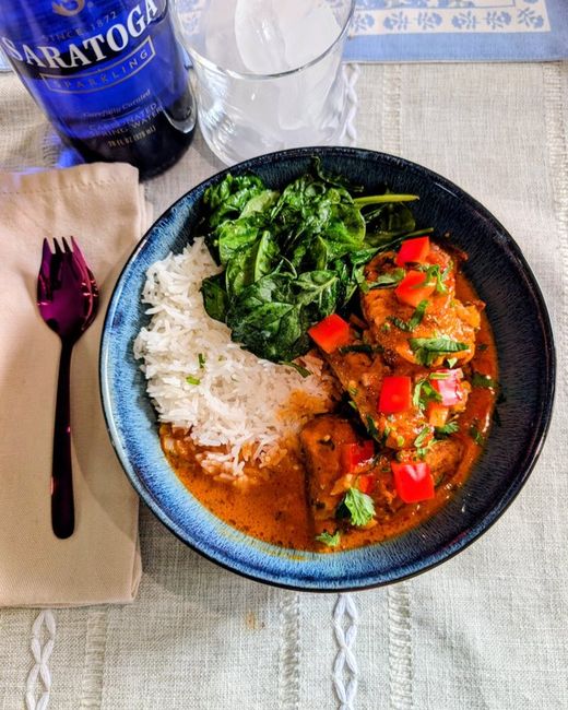 Gochujang coconut chicken in sauce over white rice with spinach