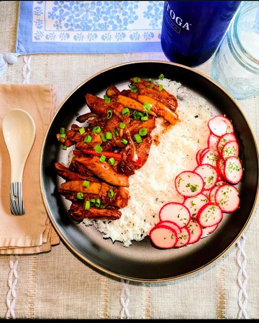 Asian style pepper chicken over rice with pickled radishes
