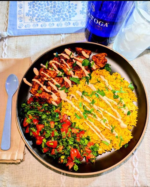 Middle eastern chicken with herbed rice, tabouleh and spicy garlic crema